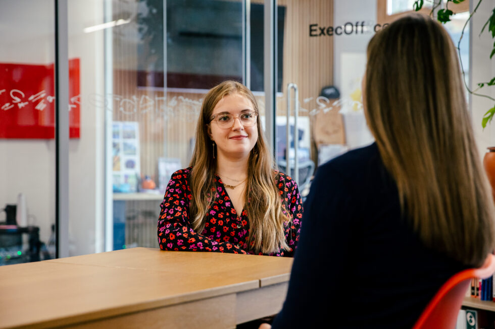 Milly Gladstone, this article's author, sat in the Cegos UK office, utilizing soft skills in a conversation.